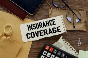 Insurance Coverage Insurance coverage text on torn paper on the background of different stationery