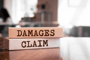 Truck accident damages Damages & Claim written on wood block