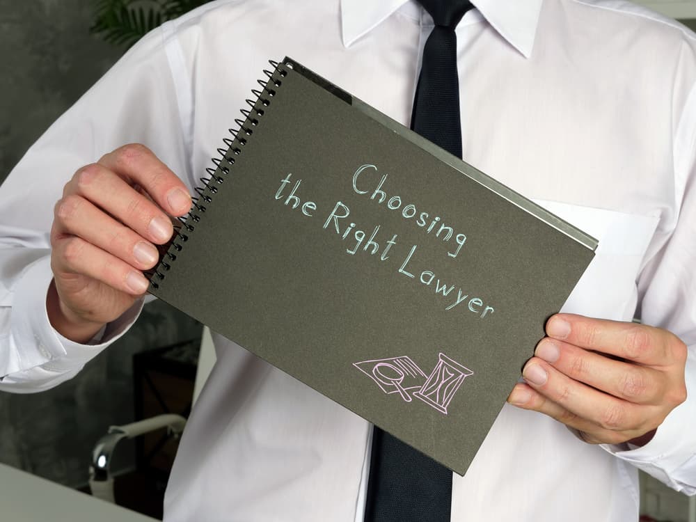 Choosing the Right Lawyer with an inscription on a piece of paper.