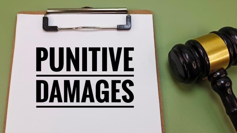 Judge’s gavel and clipboard with punitive damages text symbolizing legal penalty, court judgment, civil lawsuit, justice, compensation, and liability claims.